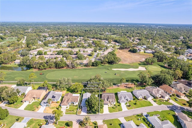aerial view of property and surrounding area featuring a local golf course, nearby suburban area, a large body of water, and property boundaries highlighted