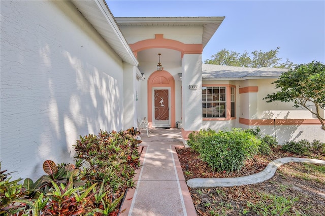 view of exterior entry featuring stucco siding