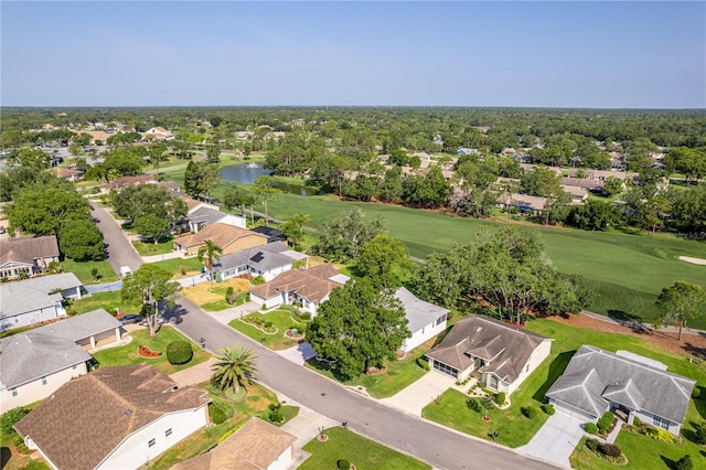 aerial perspective of suburban area featuring a large body of water and a golf club