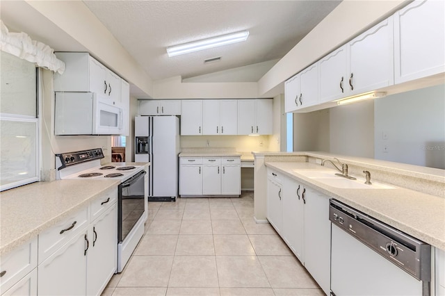 kitchen with white appliances, a sink, lofted ceiling, light countertops, and white cabinets