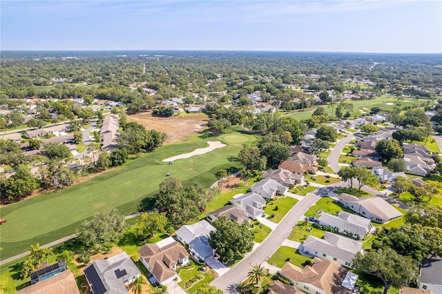 aerial overview of property's location with a golf course and nearby suburban area