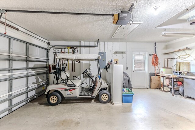 garage featuring a garage door opener and electric panel