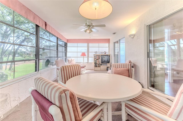sunroom with a ceiling fan