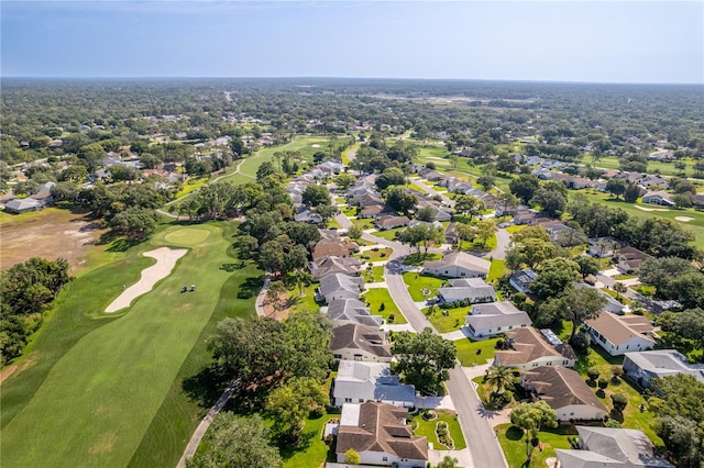 aerial view of property's location featuring a local golf course and nearby suburban area