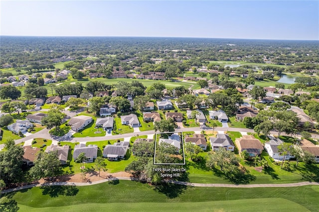 aerial view of residential area featuring a large body of water and a local golf course