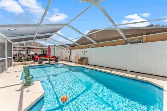 view of pool with a patio area and a lanai