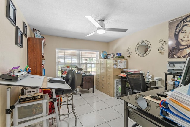 office space with ceiling fan, a textured ceiling, and light tile patterned floors