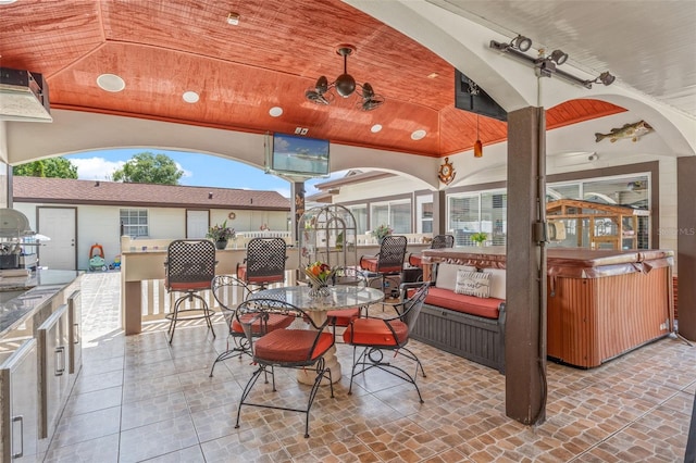 view of patio featuring a hot tub and exterior kitchen
