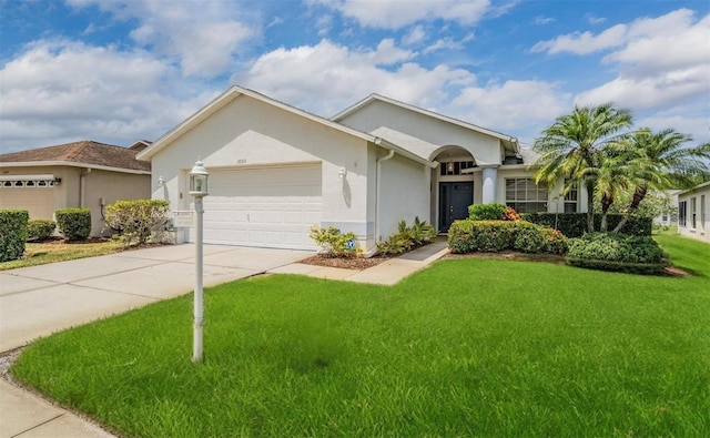 1053 Winding Willow Dr, Trinity, FL 34655 - ranch-style home with a garage, a front lawn, stucco siding, and driveway
