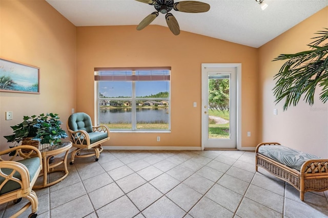 1053 Winding Willow Dr, Trinity, FL 34655 - living area featuring lofted ceiling, light tile patterned floors, a ceiling fan, and baseboards
