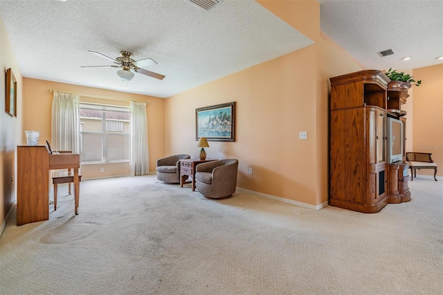 1053 Winding Willow Dr, Trinity, FL 34655 - sitting room featuring a textured ceiling, ceiling fan, carpet, and baseboards