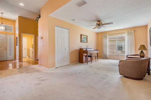 1053 Winding Willow Dr, Trinity, FL 34655 - sitting room featuring carpet, a textured ceiling, ceiling fan, baseboards, and a chandelier