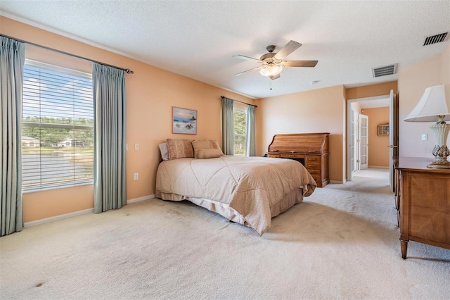 1053 Winding Willow Dr, Trinity, FL 34655 - bedroom featuring light carpet, baseboards, ceiling fan, and a textured ceiling
