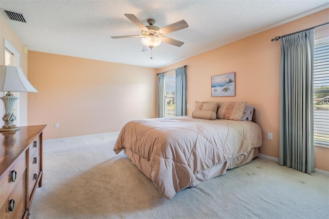1053 Winding Willow Dr, Trinity, FL 34655 - bedroom with light colored carpet, a ceiling fan, and a textured ceiling