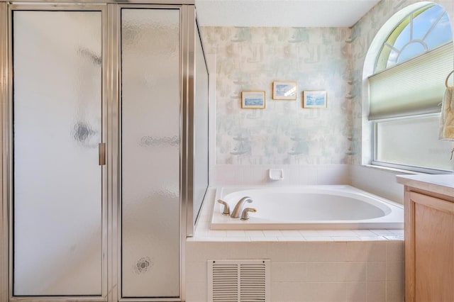 1053 Winding Willow Dr, Trinity, FL 34655 - bathroom with a stall shower, a garden tub, wallpapered walls, and vanity
