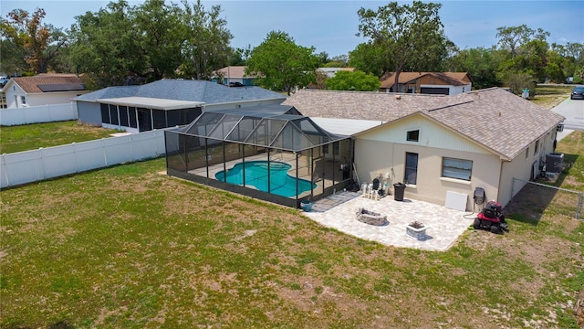 8126 Wooden Dr, Spring Hill, FL 34606 - rear view of house featuring a patio area, an outdoor fire pit, roof with shingles, glass enclosure, and central AC