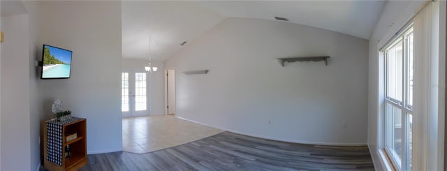 8126 Wooden Dr, Spring Hill, FL 34606 - unfurnished living room featuring vaulted ceiling, wood finished floors, a chandelier, and baseboards