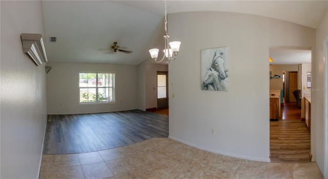 8126 Wooden Dr, Spring Hill, FL 34606 - empty room with lofted ceiling, tile patterned flooring, ceiling fan, a chandelier, and baseboards