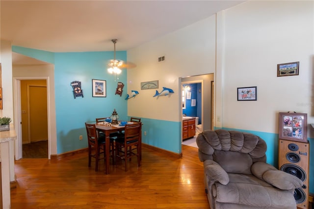 8126 Wooden Dr, Spring Hill, FL 34606 - dining area featuring wood finished floors, a ceiling fan, vaulted ceiling, and baseboards