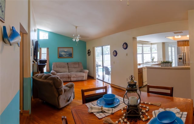 8126 Wooden Dr, Spring Hill, FL 34606 - living room featuring light wood-style flooring, vaulted ceiling, and a ceiling fan