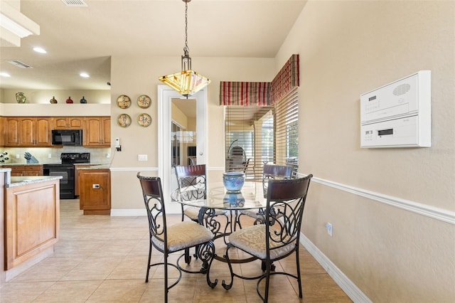 dining space featuring a chandelier, recessed lighting, light tile patterned floors, and baseboards