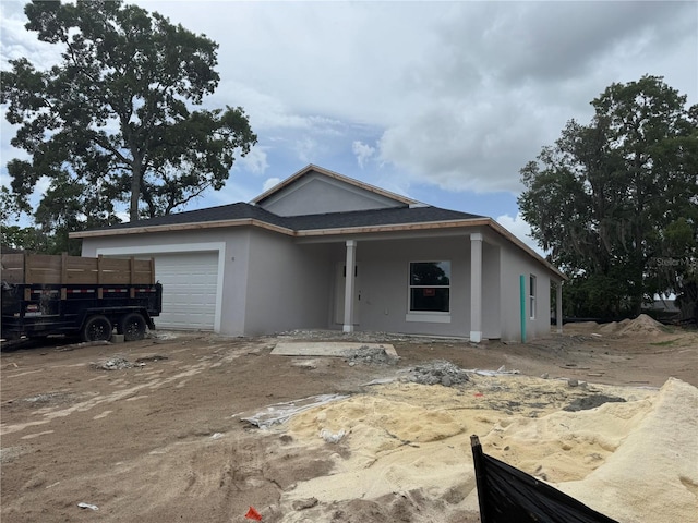 7583 St Andrews Blvd, Weeki Wachee, FL 34613 - view of front of house featuring stucco siding and an attached garage