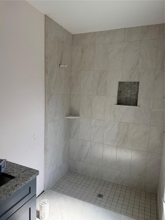 7583 St Andrews Blvd, Weeki Wachee, FL 34613 - bathroom featuring tiled shower and vanity