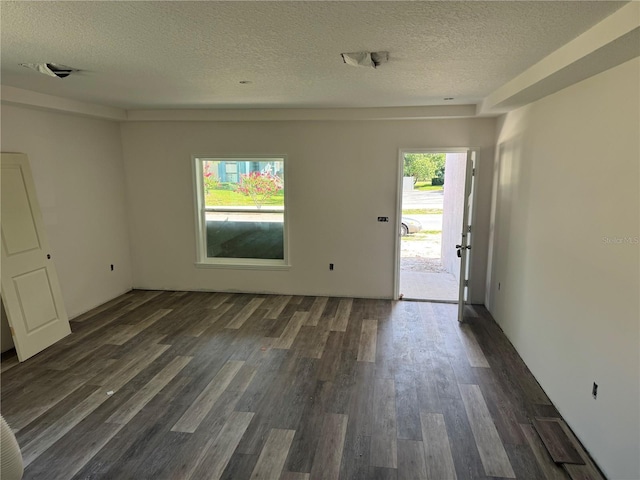 7583 St Andrews Blvd, Weeki Wachee, FL 34613 - empty room featuring a textured ceiling and dark wood-style floors
