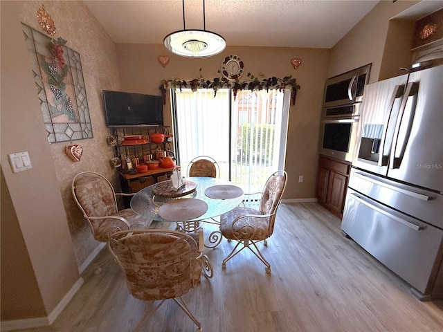 9311 Haas Dr, Hudson, FL 34669 - dining space with light wood-type flooring and baseboards