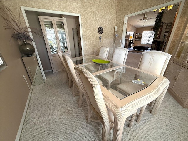 9311 Haas Dr, Hudson, FL 34669 - dining room featuring light carpet, a ceiling fan, and baseboards