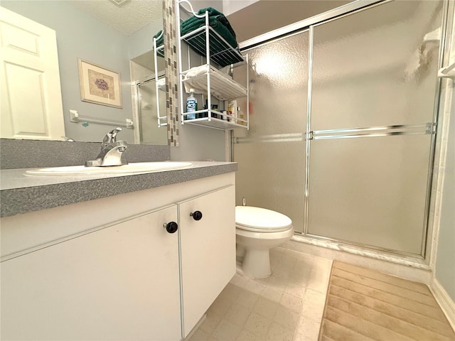 9311 Haas Dr, Hudson, FL 34669 - bathroom with a shower stall, toilet, vanity, and a textured ceiling