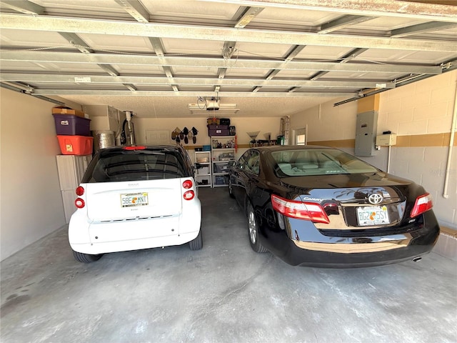 9311 Haas Dr, Hudson, FL 34669 - garage featuring electric panel and a garage door opener