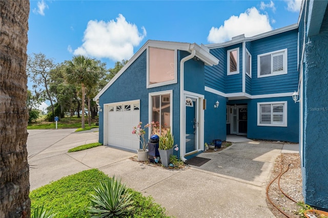 2026 Golfview Dr Unit 2026, Tarpon Springs, FL 34689 - view of front facade with concrete driveway, stucco siding, and an attached garage