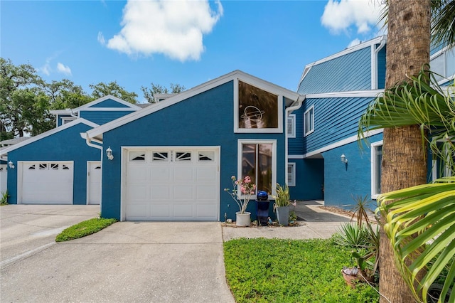 2026 Golfview Dr Unit 2026, Tarpon Springs, FL 34689 - mid-century modern home featuring driveway, stucco siding, and a garage