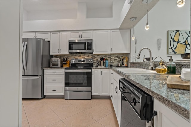 2026 Golfview Dr Unit 2026, Tarpon Springs, FL 34689 - kitchen featuring stainless steel appliances, white cabinetry, a sink, and light tile patterned floors
