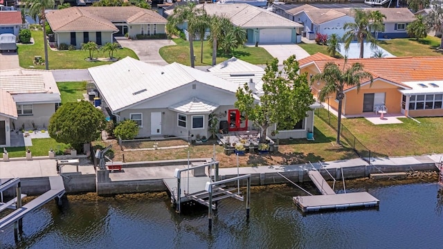 aerial view of residential area featuring a large body of water