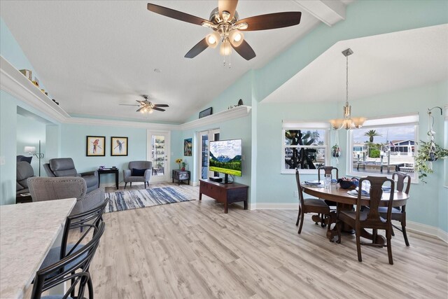 dining space with ceiling fan, light wood finished floors, baseboards, and a chandelier