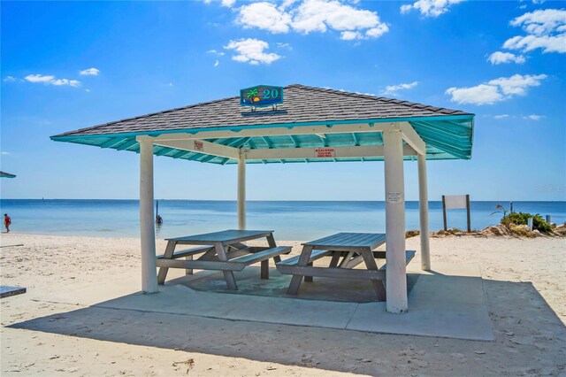 view of home's community with view of water and beach and a gazebo