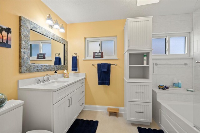 full bath with vanity, toilet, and baseboards