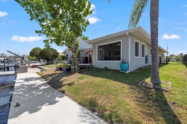 view of front facade featuring a front lawn and a boat dock