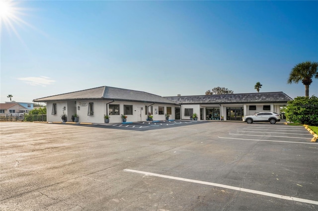 uncovered parking lot featuring fence