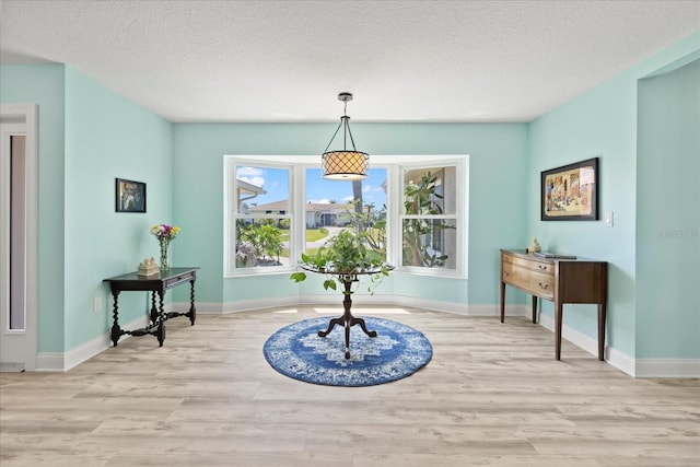 4918 Forecastle Dr, New Port Richey, FL 34652 - dining space featuring wood finished floors and a textured ceiling