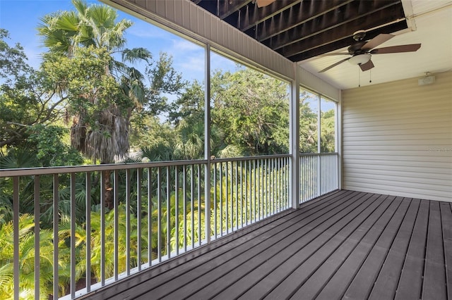 unfurnished sunroom with ceiling fan
