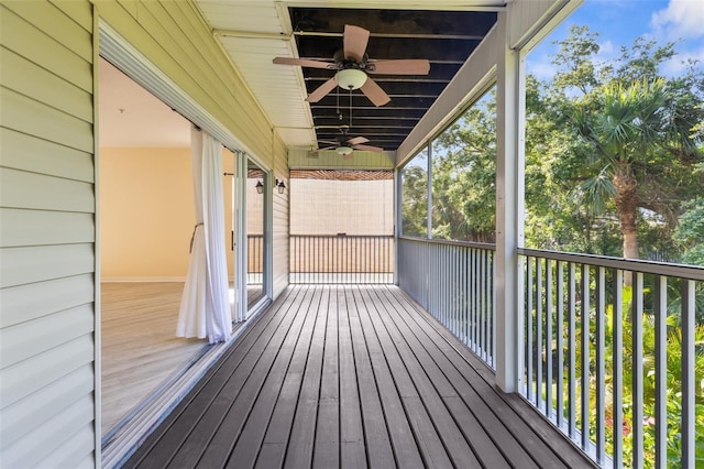 wooden deck featuring ceiling fan