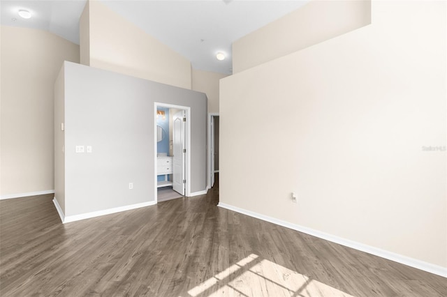 unfurnished room with wood finished floors and baseboards