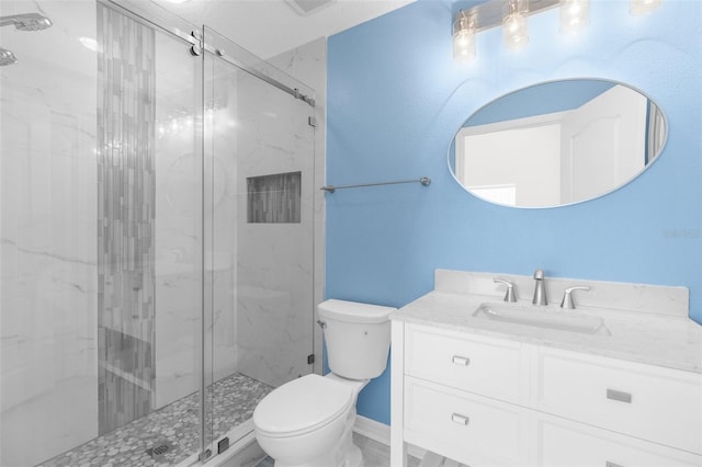full bathroom with toilet, a marble finish shower, and vanity