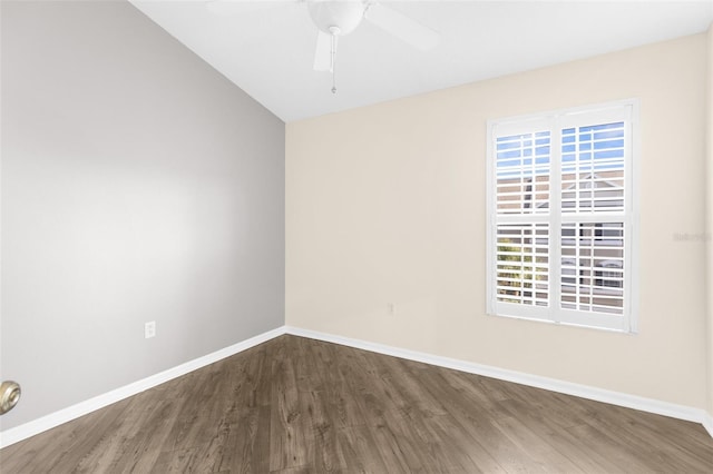 empty room featuring wood finished floors, baseboards, lofted ceiling, and ceiling fan