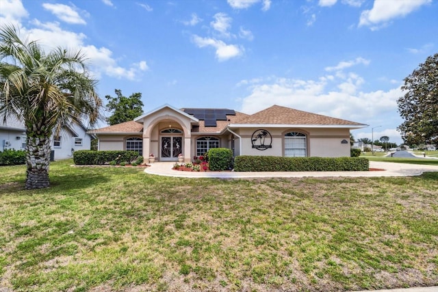 3773 E Lake Todd Dr, Hernando, FL 34442 - view of front facade with solar panels, a front lawn, and stucco siding