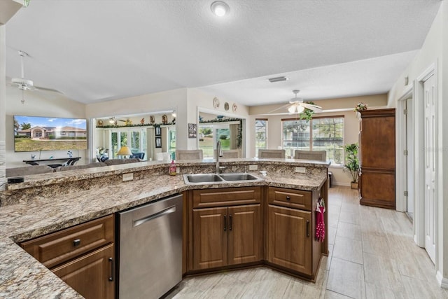 3773 E Lake Todd Dr, Hernando, FL 34442 - kitchen featuring a sink, ceiling fan, stainless steel dishwasher, light stone counters, and open floor plan