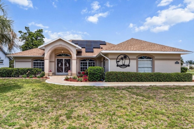 3773 E Lake Todd Dr, Hernando, FL 34442 - view of front facade featuring stucco siding, a front lawn, solar panels, and roof with shingles